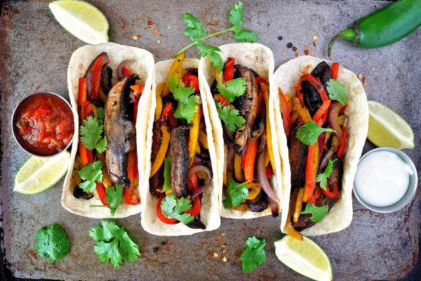 Portobello mushroom vegan fajitas. Top view on a dark background. Healthy eating, plant-based meat substitute concept.